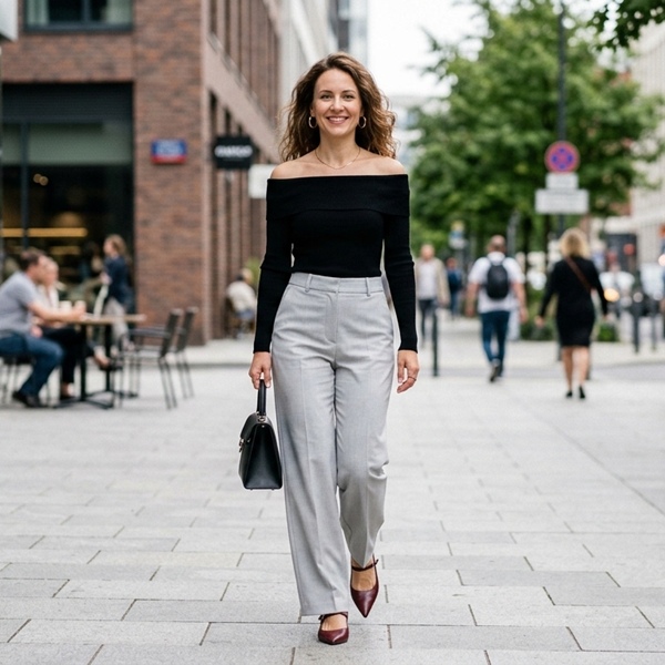 Look moderno con suéter negro escote off shoulder y pantalón